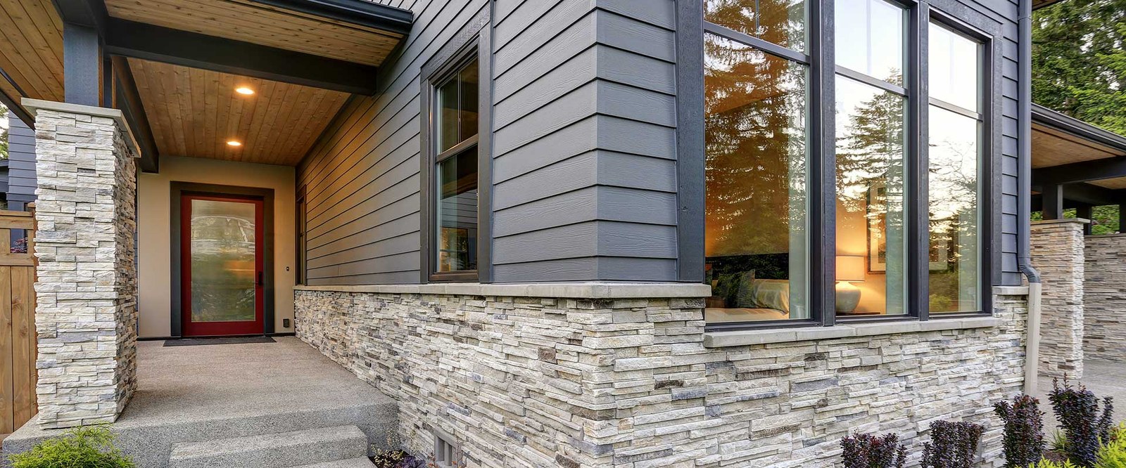 Home exterior with new siding and stone veneer