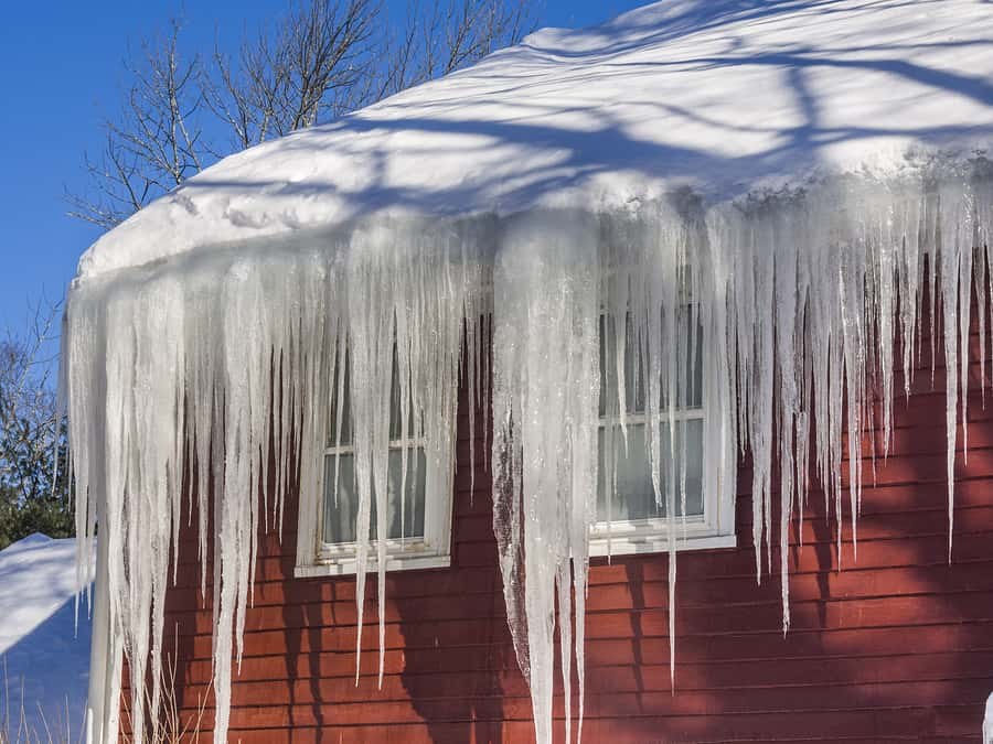 Snow and ice built up along a roof edge in winter